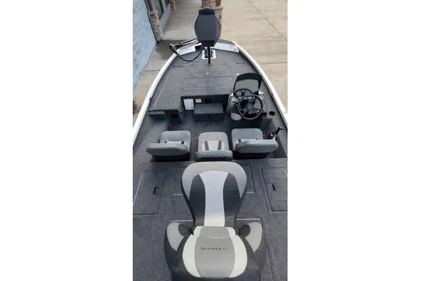 Slide: The Image of 2026 Lowe Stinger 175C fishing boat interior with seating and steering console. - 11