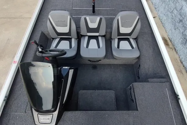 Slide: The Image of 2026 Lowe Stinger 175C boat interior with three gray seats and steering console. - 8