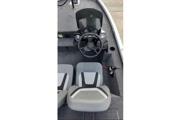 Slide: The Image of 2026 Lowe Stinger 175C boat interior with steering wheel and seating. - 9