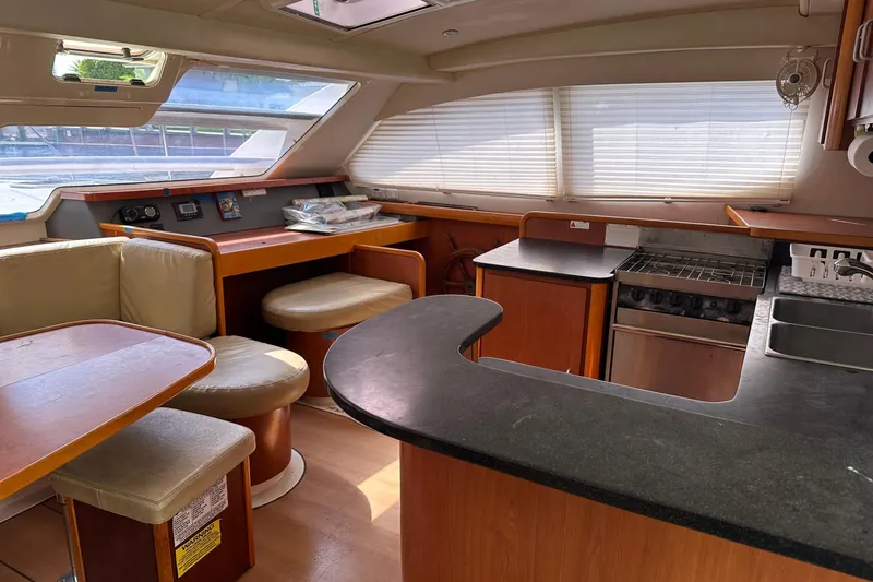 Slide: The Image of Interior of 2011 Robertson & Caine Leopard 46 yacht with kitchen and seating area. - 1