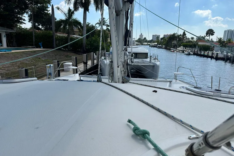 Slide: The Image of 2011 Robertson & Caine Leopard 46 catamaran docked by a scenic waterfront. - 18
