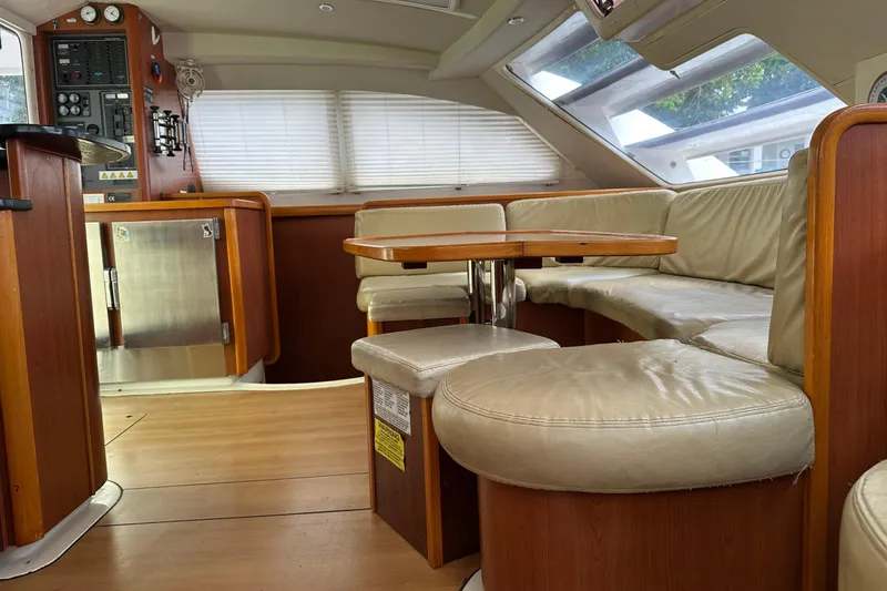 Slide: The Image of Interior of 2011 Robertson & Caine Leopard 46 yacht with leather seating and wooden finishes. - 4