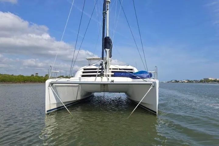 Slide: The Image of 2011 Robertson & Caine Leopard 46 catamaran on calm water, front view. - 7