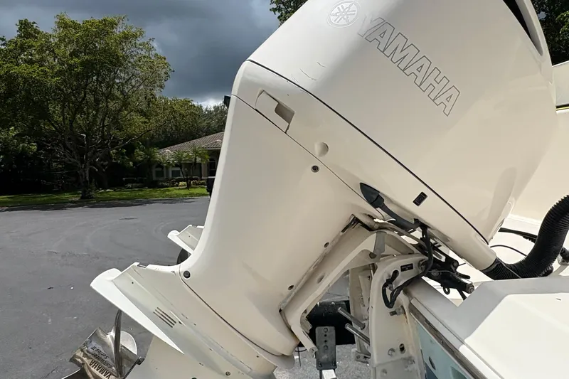 Slide: The Image of 2018 Cobia 301 Center Console with Yamaha outboard motor in a scenic outdoor setting. - 19