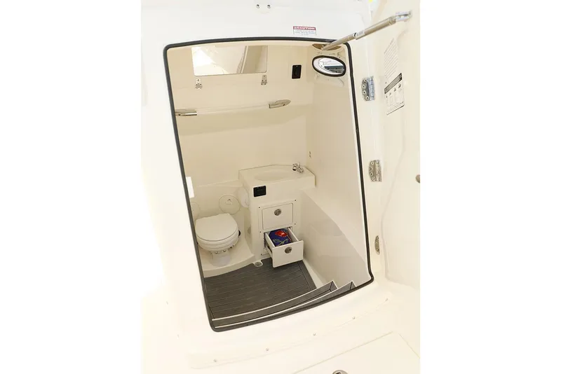 Slide: The Image of Manufacturer Provided Image: 2018 Cobia 301 Center Console boat interior with toilet and storage. - 2
