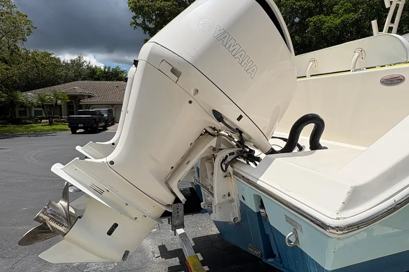 Slide: The Image of 2018 Cobia 301 Center Console with Yamaha outboard motor, parked outdoors. - 20