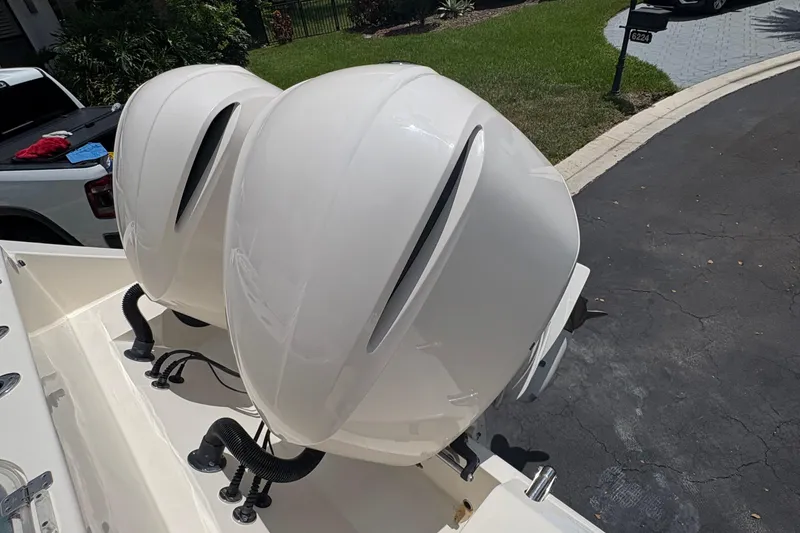 Slide: The Image of 2018 Cobia 301 Center Console with dual outboard engines in driveway. - 22