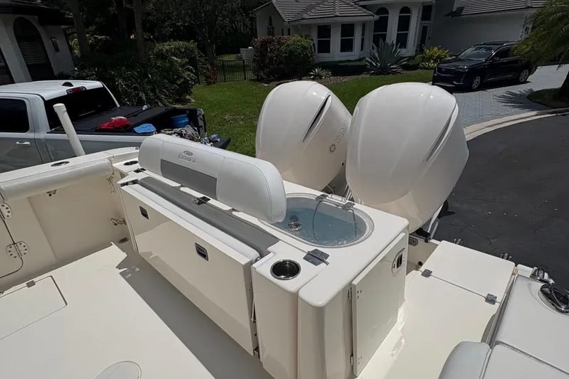 Slide: The Image of 2018 Cobia 301 Center Console boat with dual Yamaha engines and seating area. - 23