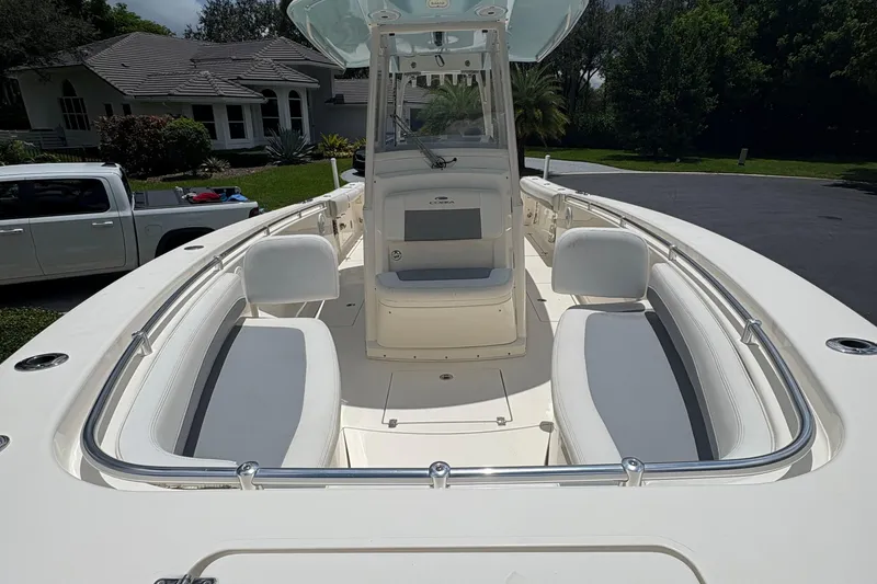Slide: The Image of 2018 Cobia 301 Center Console boat with spacious seating and sleek design. - 25