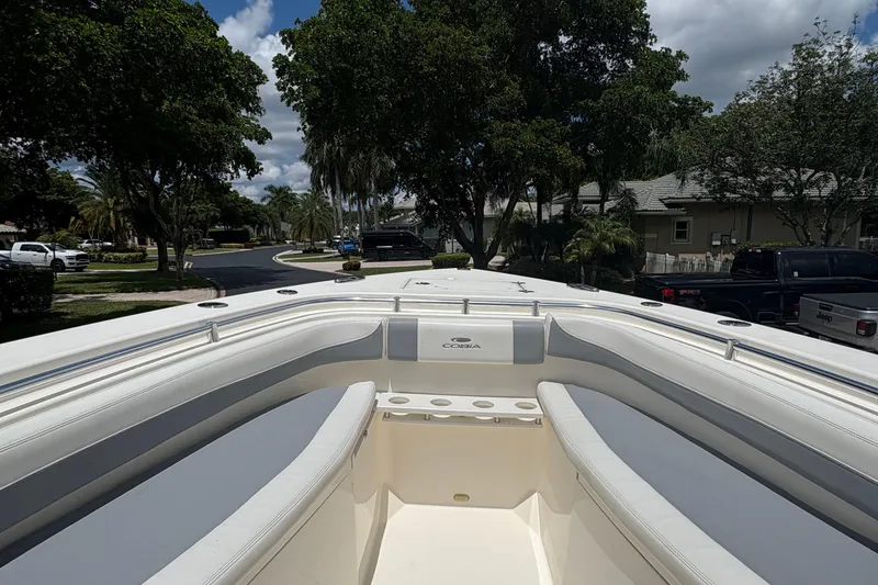 Slide: The Image of 2018 Cobia 301 Center Console boat with spacious seating and sleek design. - 28