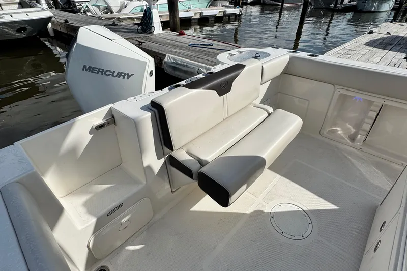 Slide: The Image of 2024 Sailfish 241 CC boat interior with Mercury engine, docked at marina. - 11