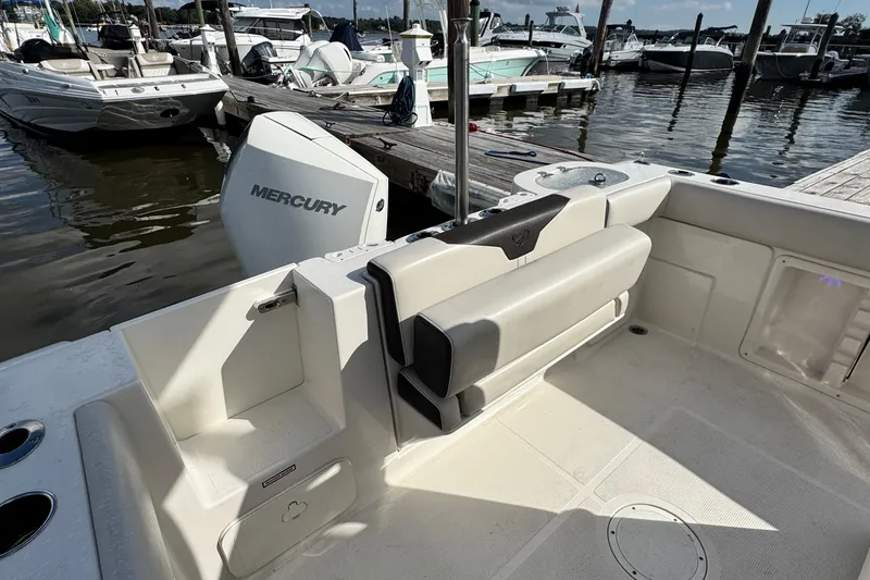 Slide: The Image of 2024 Sailfish 241 CC boat interior with Mercury engine at marina dock. - 12