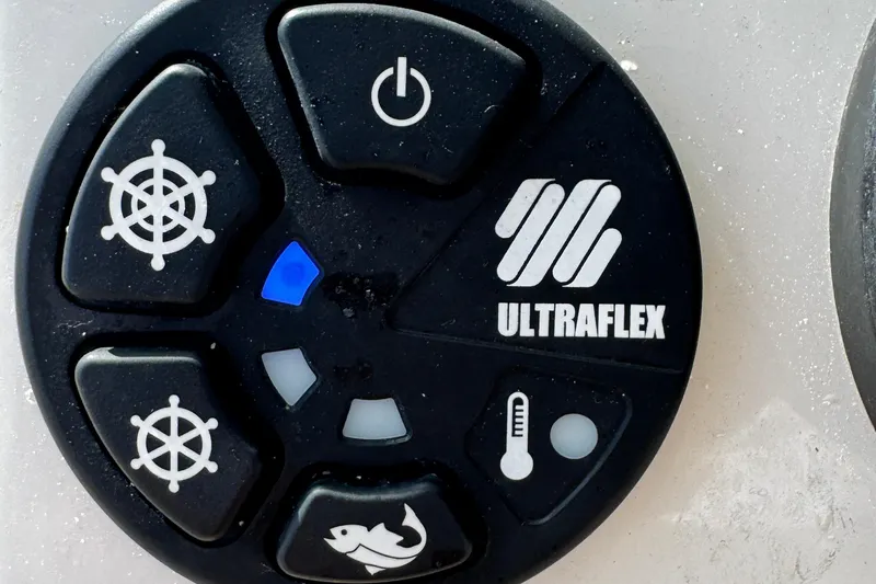 Slide: The Image of Ultraflex control panel on 2024 Sailfish 241 CC boat, featuring various function buttons. - 23