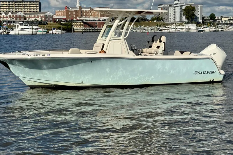 Slide: The Image of 2024 Sailfish 241 CC boat on water, with cityscape background. - 6