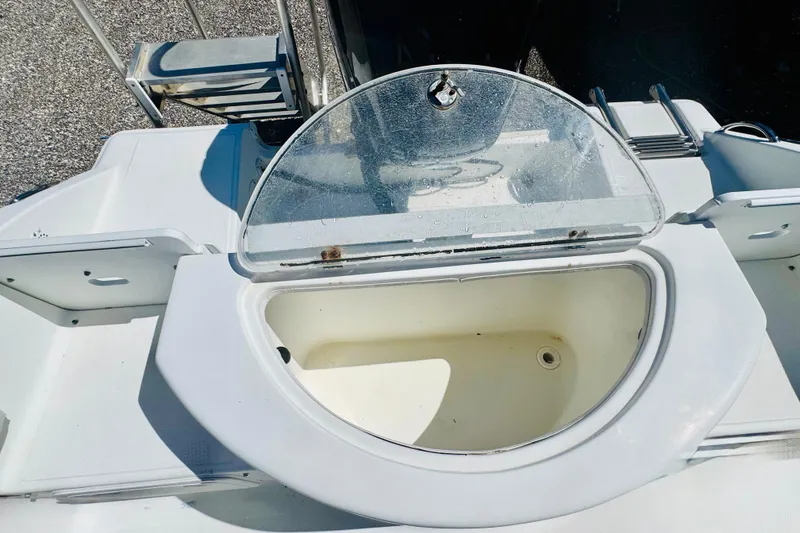 Slide: The Image of 2007 Sea Fox 236 CC boat with open storage compartment and ladder. - 11