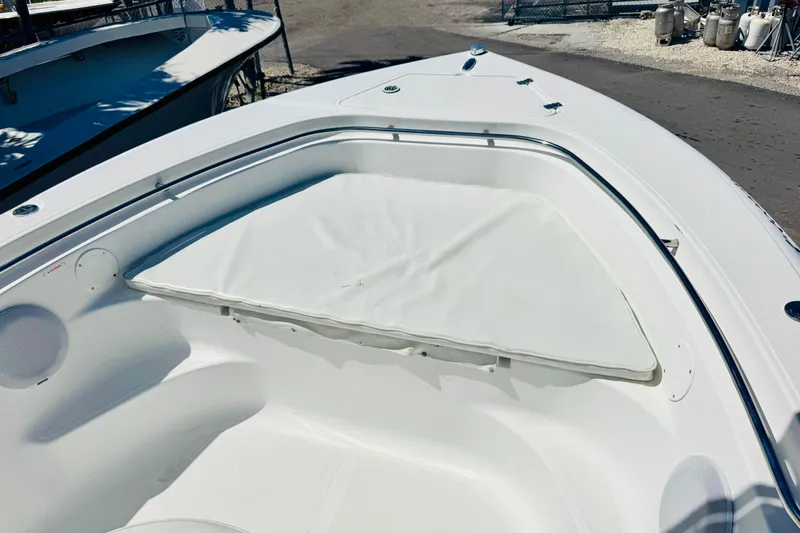 Slide: The Image of 2007 Sea Fox 236 CC boat interior with white seating and storage area. - 14