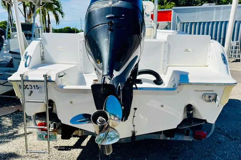 Slide: The Image of 2007 Sea Fox 236 CC boat with outboard motor and ladder, parked outdoors. - 4