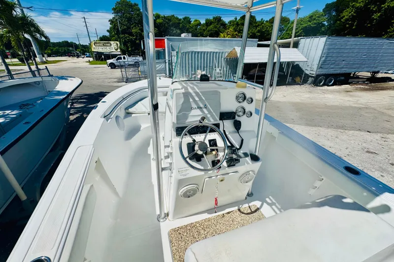 Slide: The Image of 2007 Sea Fox 236 CC boat interior with steering console and gauges, parked outdoors. - 6