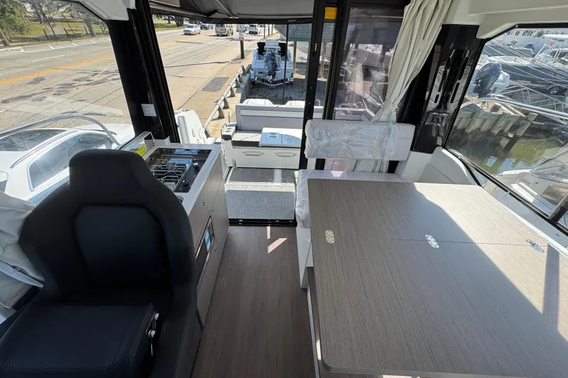 Slide: The Image of Interior of 2026 Jeanneau NC 895 Series 2 boat with seating and dining area. - 11