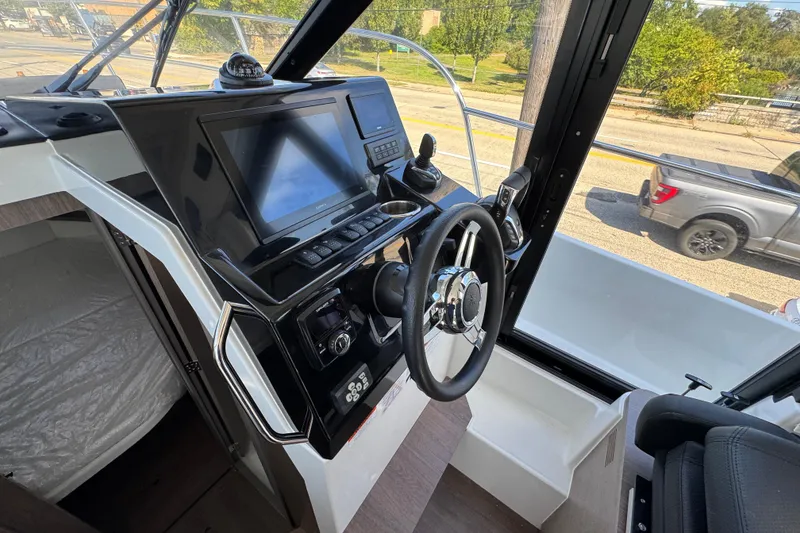 Slide: The Image of 2026 Jeanneau NC 895 Series 2 boat helm with modern controls and navigation display. - 12