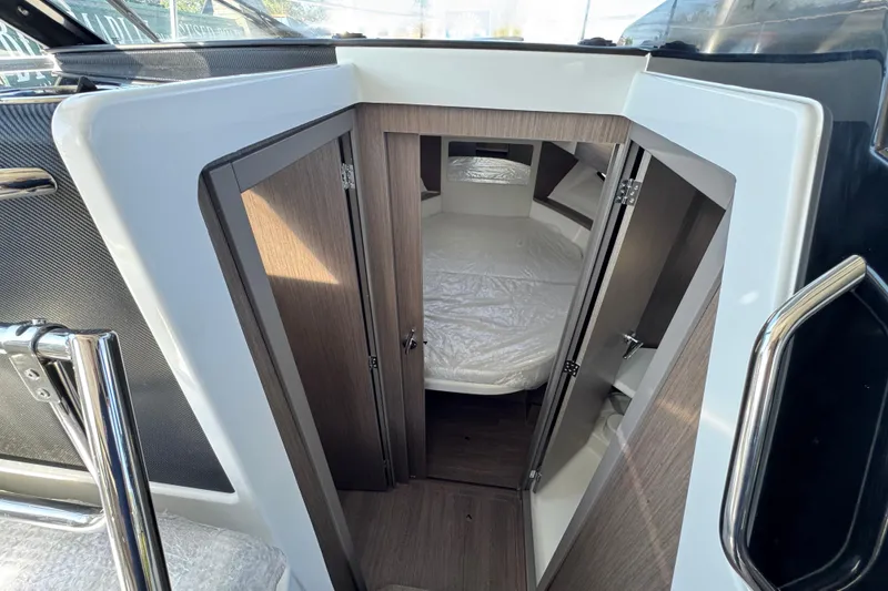 Slide: The Image of 2026 Jeanneau NC 895 Series 2 cabin interior with wood finish and cozy bed. - 19