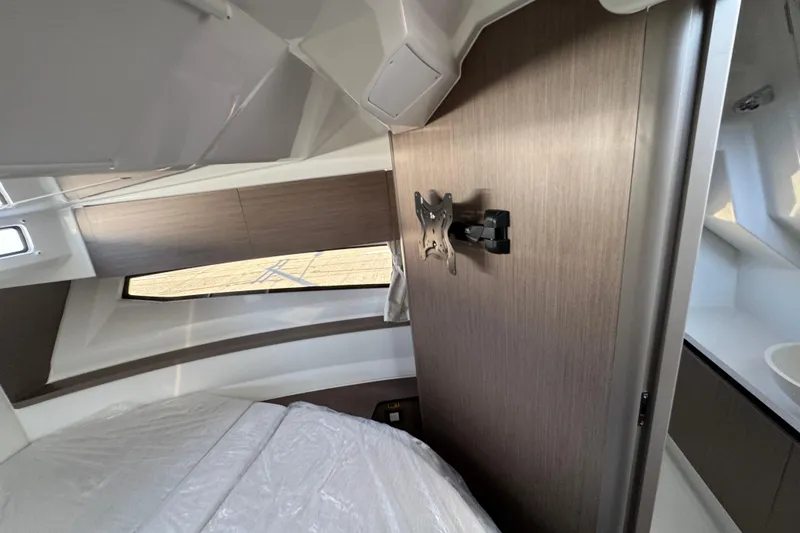 Slide: The Image of Interior cabin of 2026 Jeanneau NC 895 Series 2 boat, featuring modern wood paneling. - 22