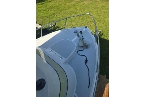 Slide: The Image of 1989 Shamrock 200 Cuddy boat deck with anchor, grassy background. - 10
