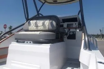Slide: The Image of 1989 Shamrock 200 Cuddy boat interior with seating and control panel. - 2