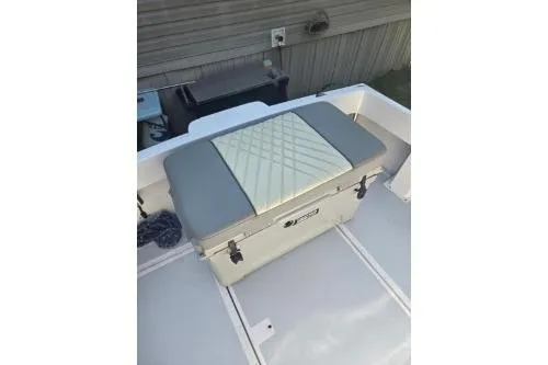 Slide: The Image of 1989 Shamrock 200 Cuddy boat with cushioned seating and storage compartment. - 5