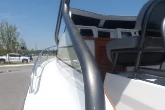 Slide: The Image of 1989 Shamrock 200 Cuddy boat, close-up of deck and seating area under clear blue sky. - 6