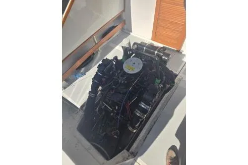 Slide: The Image of 1989 Shamrock 200 Cuddy boat engine compartment with visible engine components. - 9