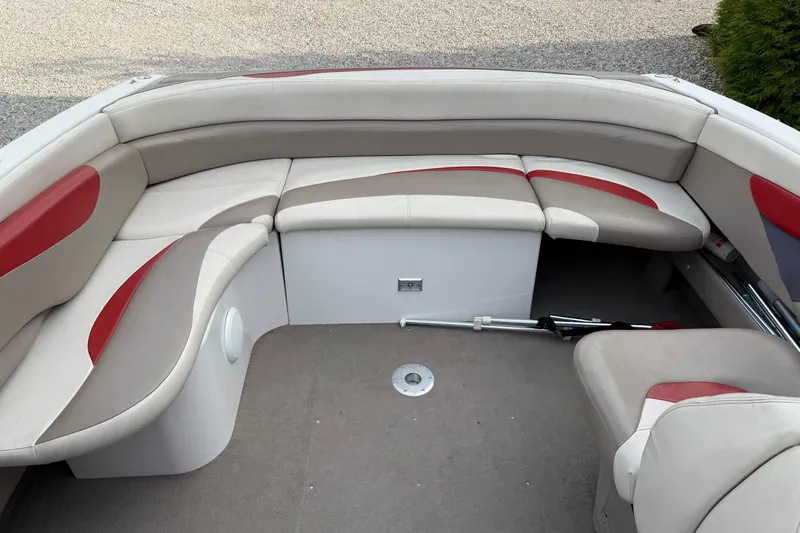 Slide: The Image of 1996 Four Winns 240 HORIZON DLX boat interior with beige and red seating. - 13