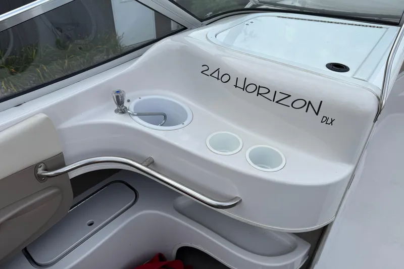 Slide: The Image of 1996 Four Winns 240 Horizon DLX boat interior with sink and cup holders. - 15