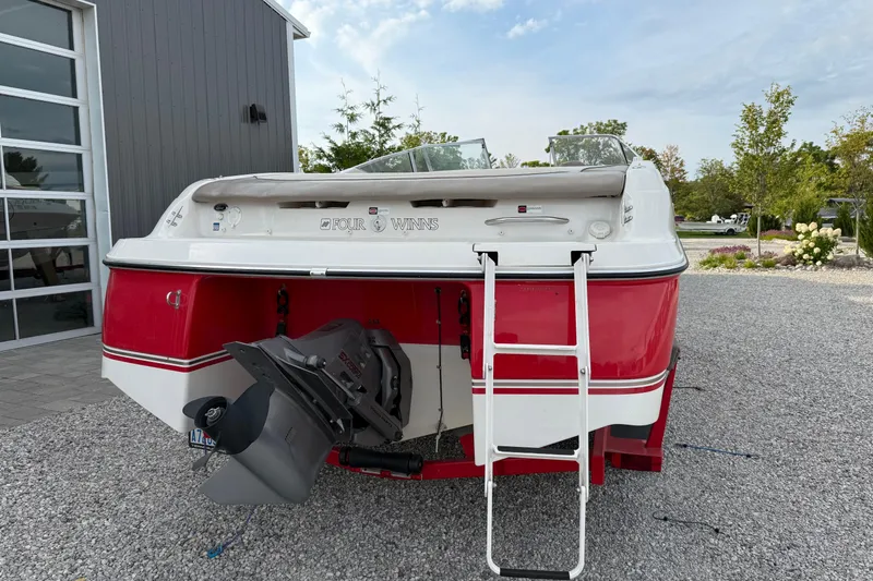 Slide: The Image of 1996 Four Winns 240 Horizon DLX boat, red and white, parked on gravel. - 5