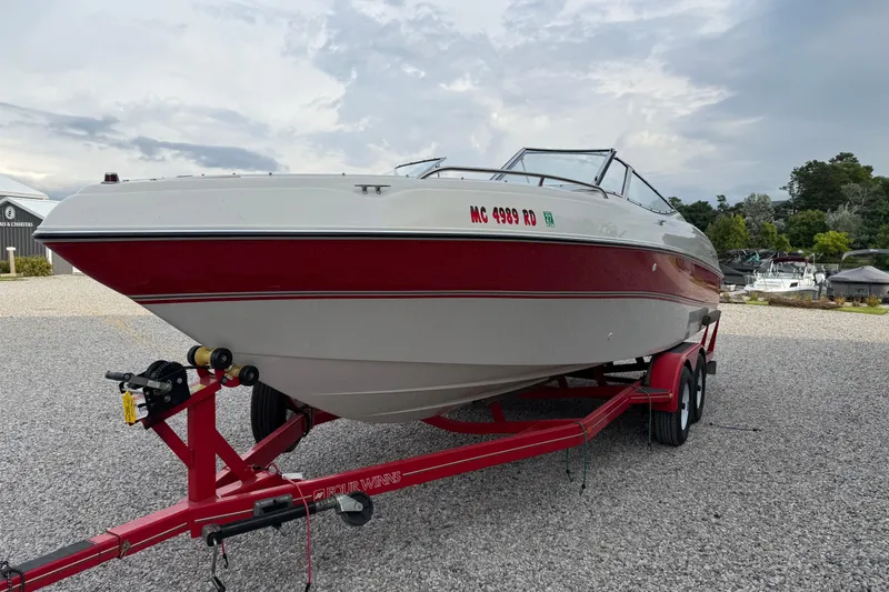 Slide: The Image of 1996 Four Winns 240 Horizon DLX boat on red trailer, parked on gravel. - 7