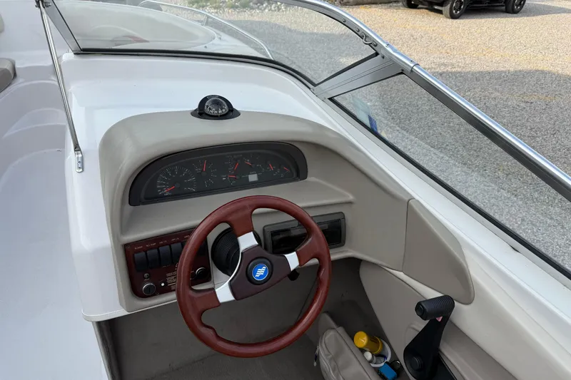 Slide: The Image of 1996 Four Winns 240 Horizon DLX boat dashboard with steering wheel and instrument panel. - 8