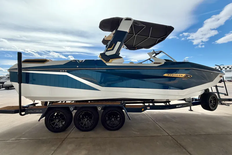 Slide: The Image of 2025 Nautique Super Air Nautique G25 Paragon boat on trailer, side view. - 11