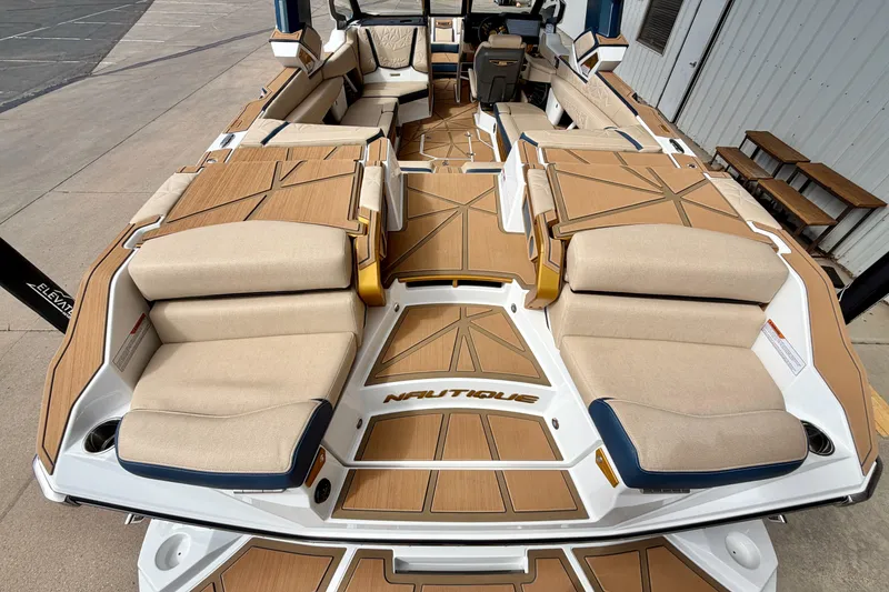 Slide: The Image of 2025 Nautique Super Air Nautique G25 Paragon interior with luxurious seating and teak flooring. - 14