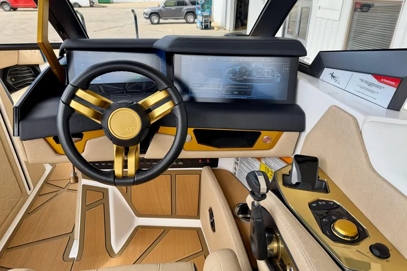 Slide: The Image of 2025 Nautique Super Air Nautique G25 Paragon cockpit with gold accents and advanced controls. - 20