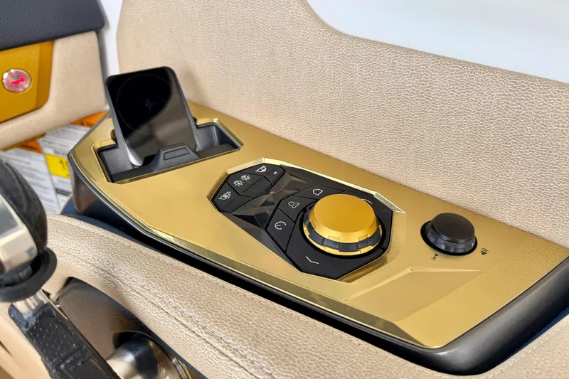 Slide: The Image of Control panel of 2025 Nautique Super Air Nautique G25 Paragon with gold accents. - 21
