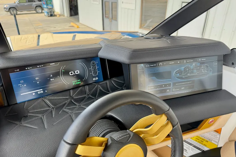 Slide: The Image of 2025 Nautique Super Air Nautique G25 Paragon dashboard with dual digital displays. - 22