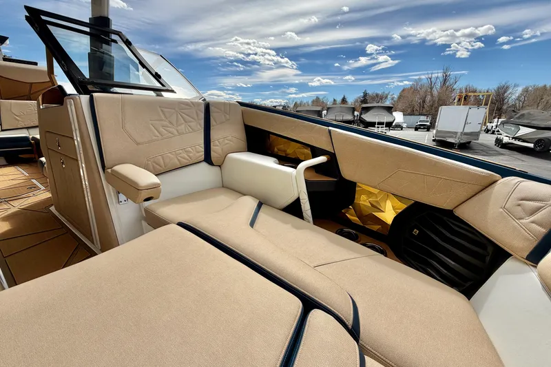 Slide: The Image of Luxurious interior of 2025 Nautique Super Air Nautique G25 Paragon boat under a clear sky. - 28