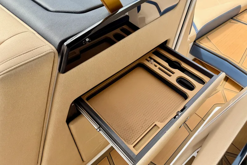 Slide: The Image of Interior view of 2025 Nautique Super Air Nautique G25 Paragon with open storage drawer. - 33