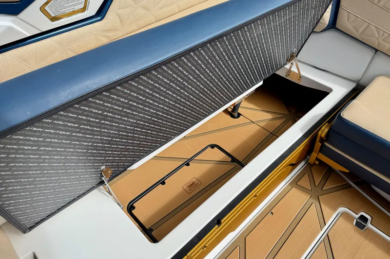 Slide: The Image of 2025 Nautique Super Air Nautique G25 Paragon storage compartment with luxury seating and detailed interior. - 38