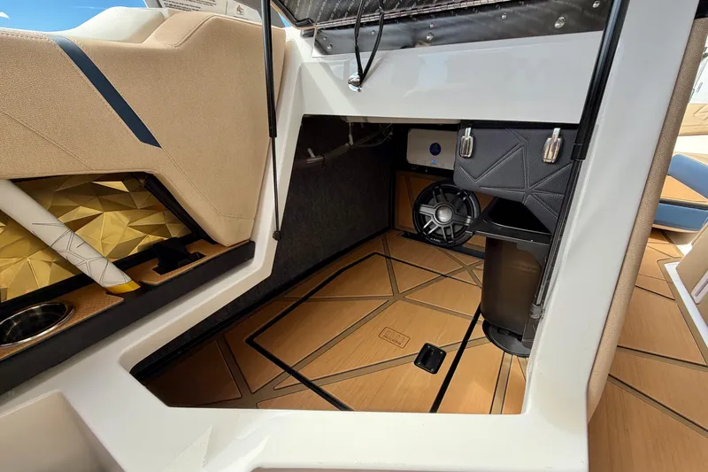 Slide: The Image of Interior of 2025 Nautique Super Air Nautique G25 Paragon boat, featuring luxury seating and speaker system. - 39