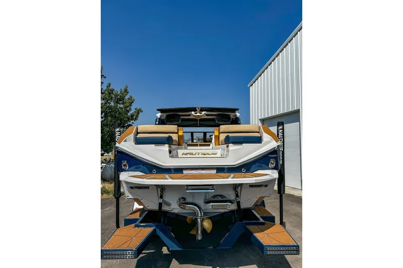 Slide: The Image of 2025 Nautique Super Air Nautique G25 Paragon boat, rear view, outdoors. - 4