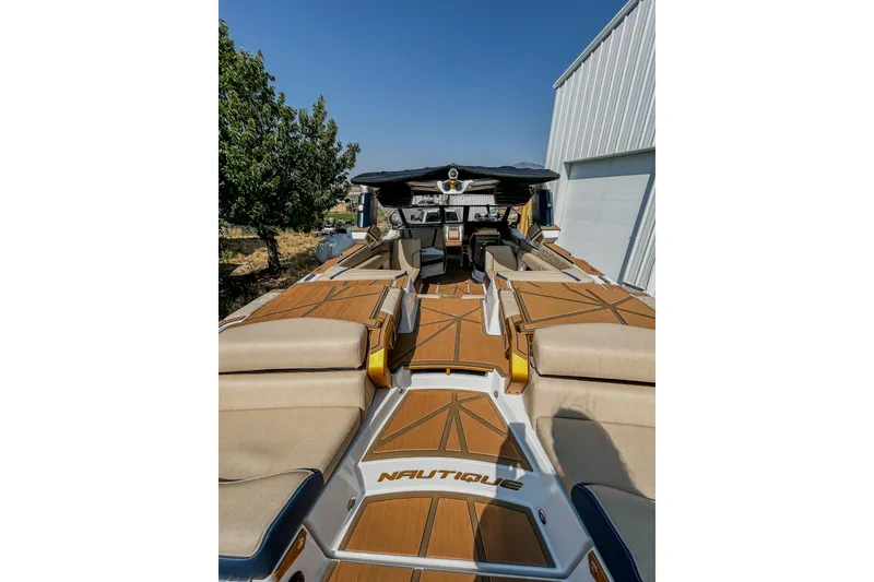 Slide: The Image of 2025 Nautique Super Air Nautique G25 Paragon boat interior with luxurious seating and deck. - 6