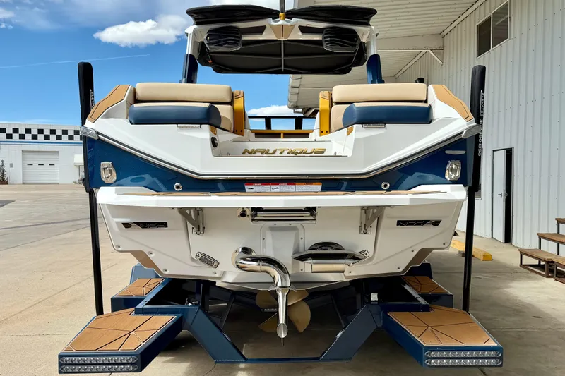 Slide: The Image of 2025 Nautique Super Air Nautique G25 Paragon boat, rear view, docked outdoors. - 9