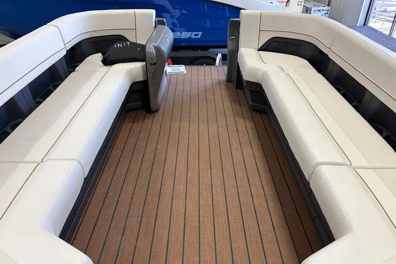 Slide: The Image of 2023 Manitou EXPLORE 26 SHP 575 boat interior with beige seating and wood-style flooring. - 14