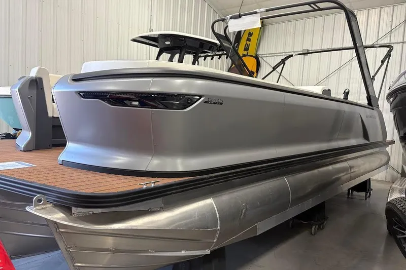 Slide: The Image of 2023 Manitou EXPLORE 26 SHP 575 pontoon boat in a showroom setting. - 3